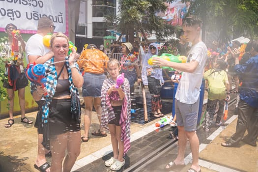 Siam Square, Bangkok, Thailand - APR 13, 2023 Songkran Festival, The short action of people joins celebrations of the Thai New Year or Songkran in Siam Square Bangkok, Thailand.