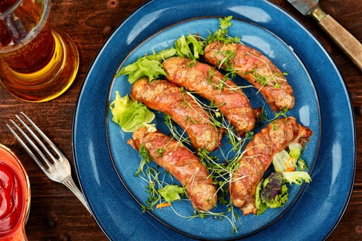 Fried sausage on plate, fast food. Barbecue bratwurst, top view.