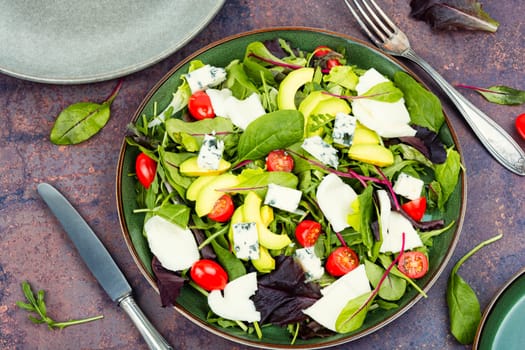 Greek salad of vegetables, fresh green lettuce and cheese