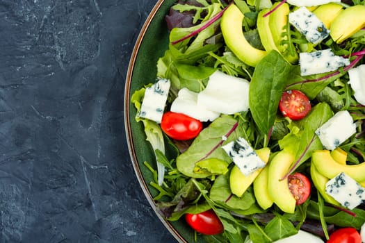 Greek salad of vegetables, fresh green lettuce and cheese