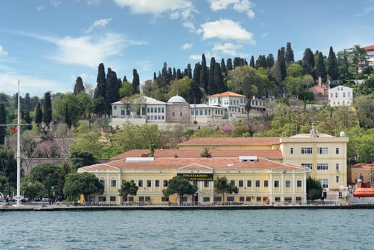 Istanbul, Turkey - May 8 2023: Ziya Kalkavan Vocational and Technical Anatolian High School in Ortakoy, Besiktas, located on the shores of the Bosphorus Strait with beautiful view of the city skyline