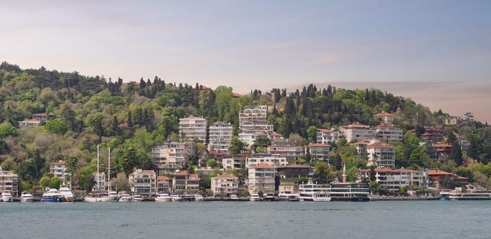 Istanbul, Turkey - May 8, 2023: Stunning view of the Bebek neighborhood, with its traditional colorful buildings perched on a hill overlooking the Bosphorus Strait