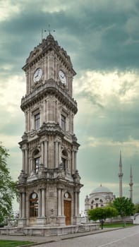 Day shot of Dolmabahce Clock Tower, Turkish: Dolmabahce Saat Kulesi, situated outside Dolmabahce Palace, Istanbul, Turkey, with Baroque style Dolmabahce Mosque in the background