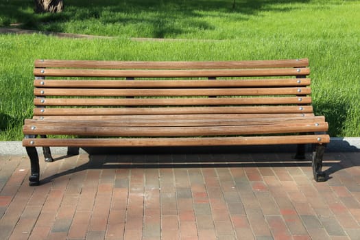 wooden bench in the park. beautiful bench in city park. Empty bench in beautiful park with green grass. Summer park with place for rest