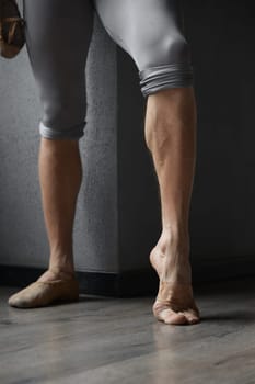 Strong trained legs of male ballet dancer cropped shot. Hard work and training for dance movement perfection
