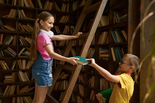 Children being on duty putting away books in home or school library. Family relationships between siblings or schoolkid nice behavior