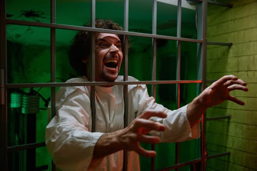 Mentally ill male patient with attack of rabies locked in cage ward. Psychiatric department in clinic and mad people treatment