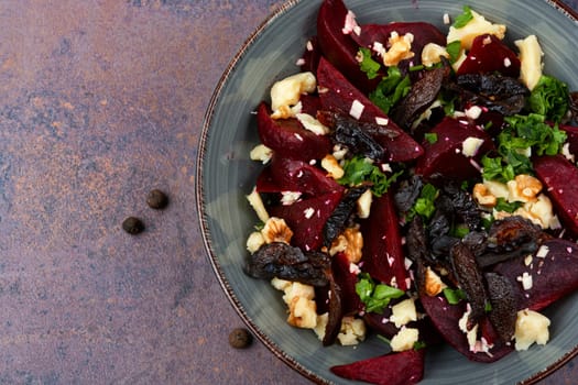 Diet salad of boiled beets, nuts and cheese on the plate. Beet or beetroot salad.