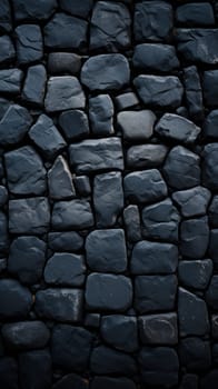 masonry of rough gray stones of various shapes and shades on the pavement. Beautiful background and surface texture of stone road