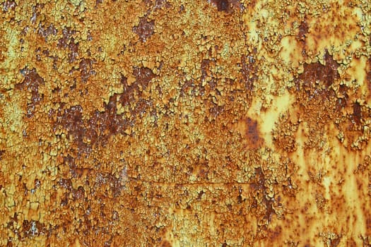 Detail of the flakes of cracked paint on an old iron