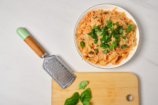 Top view of plate with fettuccine pasta on a table