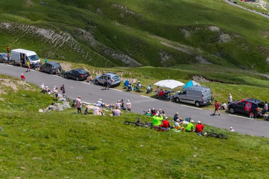 Col du Tourmalet, France - July 06 2023: Cycling fans waiting for the buch at the top of the Col du Tourmalet in Pyerenees mountains during the stage 6 of Le Tour de France 2023