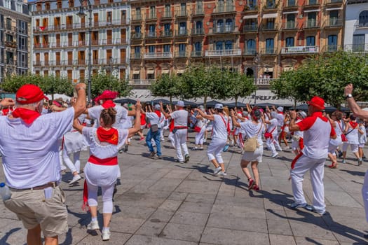 Pamplona, Spain: 09 July 2023: People celebrate San Fermin festival in traditional white abd red clothing with red necktie, Pamplona, Navarra, Spain.