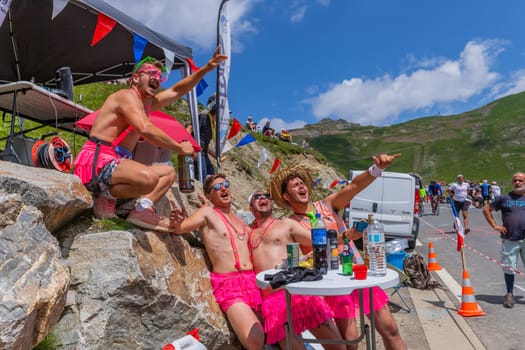 Col du Tourmalet, France - July 06 2023: Cycling fans waiting for the buch at the top of the Col du Tourmalet in Pyerenees mountains during the stage 6 of Le Tour de France 2023