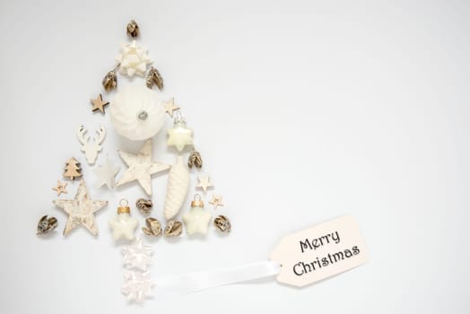 Whiter Background With A Christmas Tree Out Of Christmas Decoration, With A Label With Text Merry Christmas