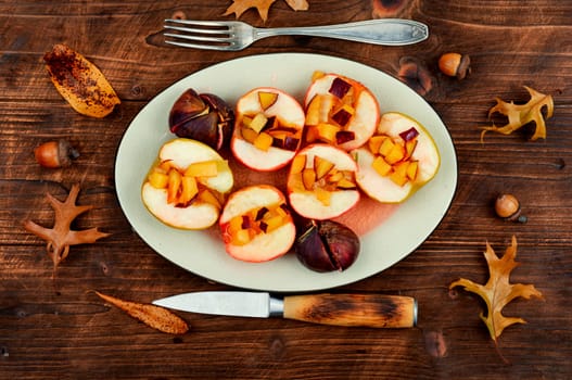 Baked sweet halves apples and figs. Homemade vegan dessert