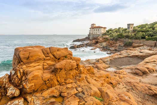 Livorno, Italy - 01 July 2023: Boccale Castle, seascape sunset. Rock and sea water.