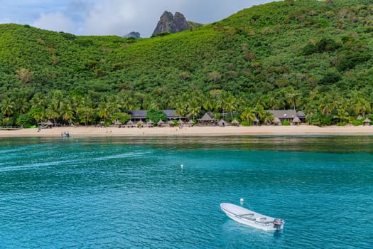 Nacula, Fiji: 26 May 2023: Tourist boats at the tropical island of Naviti, Yasawa Islands, Fiji. This archipelago consists of about 20 volcanic islands