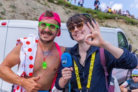Col du Tourmalet, France - July 06 2023: Cycling fans waiting for the buch at the top of the Col du Tourmalet in Pyerenees mountains during the stage 6 of Le Tour de France 2023
