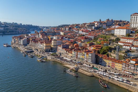 Porto, Portugal - March 02, 2023: View of Ribeira historical quarter on the margin Douro river embankment in the old town and Luis I bridge, Porto, Portugal.