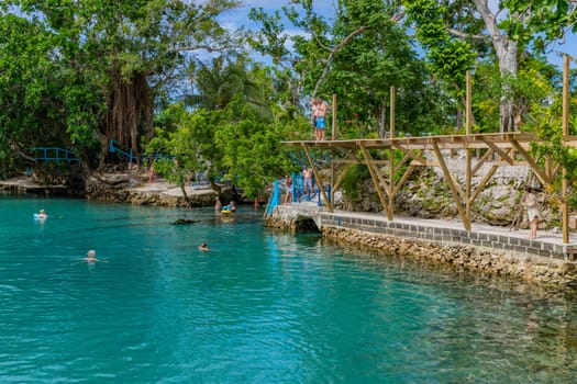 Port Vila, Vanuatu: 01 June 2023: People swimming in Blue Lagoon, a popular scenic turquoise swimming hole near Port Vila, Efate Island, Vanuatu, Melanesia