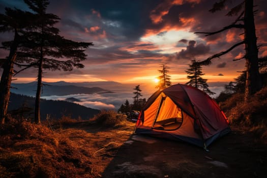 Tourist tent in the mountains under dramatic evening sky. Colorfull sunset in mountains. Camping travell concept. Traveler people enjoying the advanture alternative vacation.
