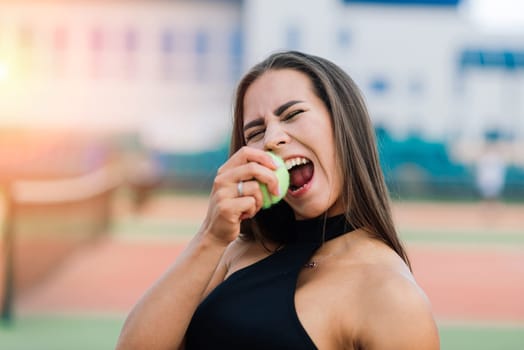 Beautiful stylish sexy woman in a trendy sportswear on tennis court.