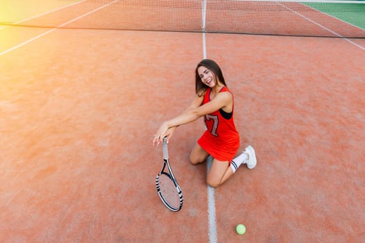 Beautiful stylish sexy woman in a trendy sportswear on tennis court.