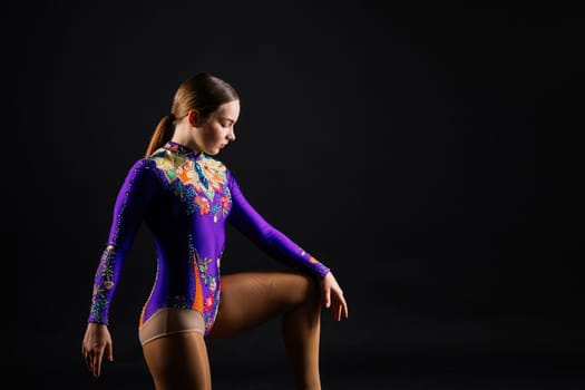 Portrait of a beautiful young woman gymnast training calilisthenics exercise with acrobatic element