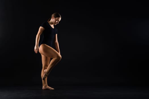 Portrait of a beautiful young woman gymnast training calilisthenics exercise with acrobatic element