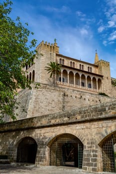 Royal Palace of La Almudaina next to cathedral La Seu. One of the official residences of the Spanish royal family. City Palma de Mallorca. Balearic Islands Spain. Travel agency vacation concept.