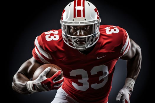 American football player in red jersey and helmet holding ball against black