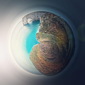 Sightseeing panoramic view to the Porte d'Aval arch cliff as a micro planet in space. Ocean waters continental side of Etretat, Normandy, France. Beautiful coastline scenery of famous Falaise d'Aval