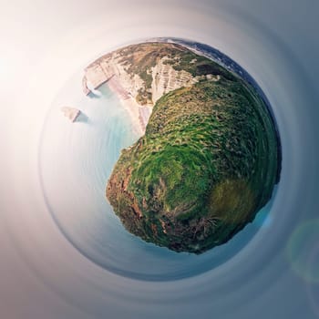 Sightseeing panoramic view to the Falaise d'Aval limestone cliffs as a micro planet in space. La Manche waters and continental side of Etretat, Normandy, France. Coastline scenery with rock Aiguille