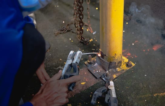 Industry worker welding steel structure at work background.