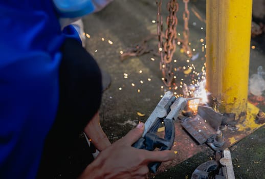 Industry worker welding steel structure at work background.