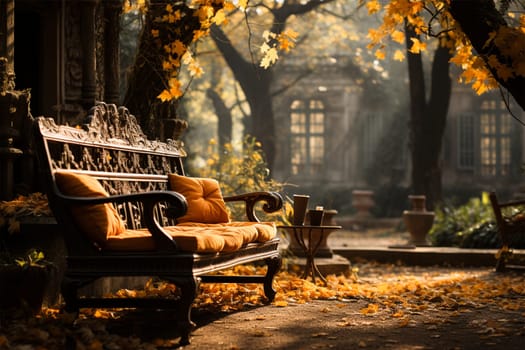 bench with soft cushions near an autumn park path with fallen yellow fresh leaves. Beautiful colors and great ambience against the backdrop of the house.