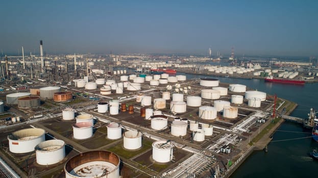 Oil refinery plant from industry zone, Aerial view oil and gas industrial, Refinery factory oil storage tank and pipeline steel
