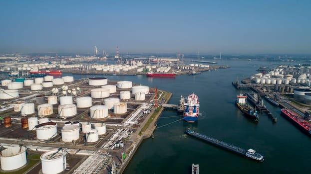 Port of Rotterdam. Botlek. Oil refinery plant from industry zone, Aerial view oil and gas industrial, Refinery factory oil storage tank and pipeline steel