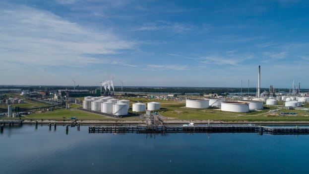 Port of Rotterdam. Botlek. Oil refinery plant from industry zone, Aerial view oil and gas industrial, Refinery factory oil storage tank and pipeline steel