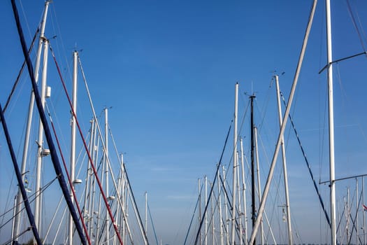 Sailboat harbor, many beautiful moored sail yachts in the sea port, modern water transport, summertime vacation, luxury lifestyle and wealth concept