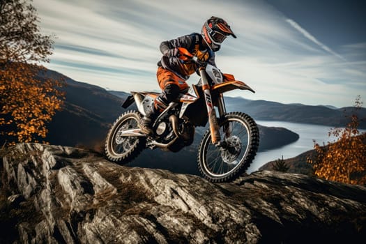 Professional motorcyclist in full moto equipment climbing rocky mountain top. Extreme rider on off-road cross enduro motorcycle with  beautiful mountains landscape down on background, with autumn forest and lake. AI generated
