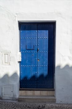 Vintage window and blue door on old traditional house in Andalusia, Spain