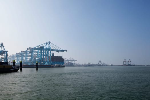 Rotterdam, Holland. Aerial view of container terminal in the harbor MAASVLAKTE, Netherlands. A large containership is unloading