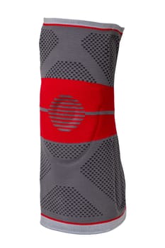 Knee pads isolated. Close-up of a red gray sports elastic knee pad or bandage to fixing and supporting joints. Clipping path. Volleyball, jogging, running or Fitnesstraining.