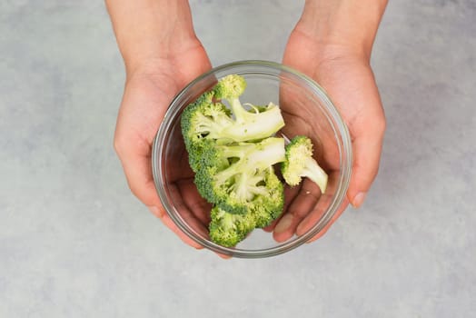 Holding fresh organic broccoli in the hand, prepare healthy food with vegetables, harvest and agriculture