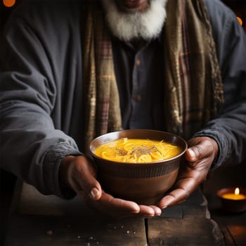 hands of a homeless person receiving a bowl of hot food at a volunteer center.concept of care and assistance to the homeless, the poor and those affected by natural disasters and wars.