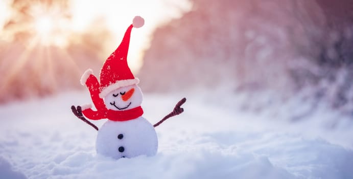 Little handmade snowman on the white snow on snowy background. Beautiful panoramic view.