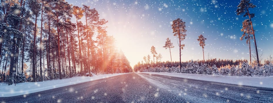 Beautiful winter road in natural sunny park. Panoramic view of the snowy street.