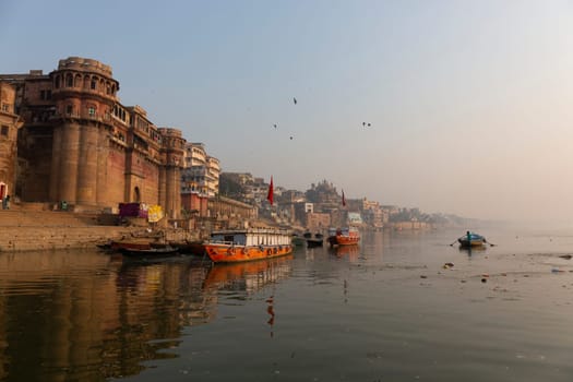 Morning view of Ganges river in Varanasi, India. Ghats with boats and people. Popular landmark, Varanasi, India